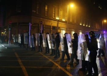 Garda police officers in riot gear line up on O'Connell Street after violence broke out on November 23rd, 2023.