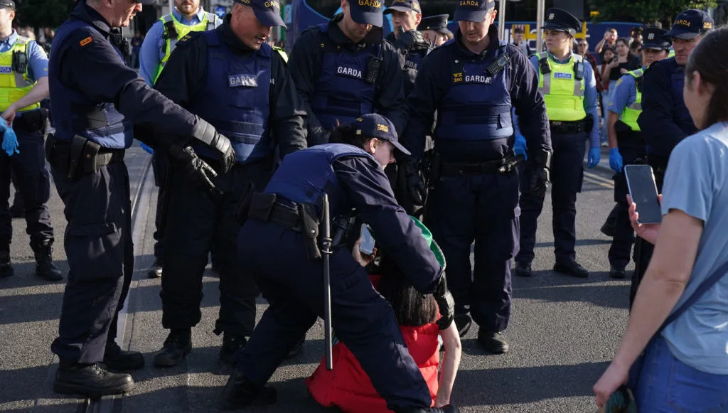 Gardaí remove a protester from O'Connell Bridge, during an anti-immigration protest.