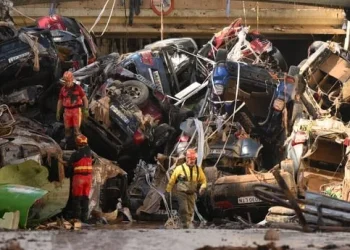 Members of the fire brigade carry out work as cars and debris block a tunnel near the Benetusser municipality