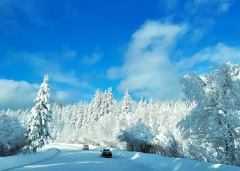 A car driving down a snow covered road