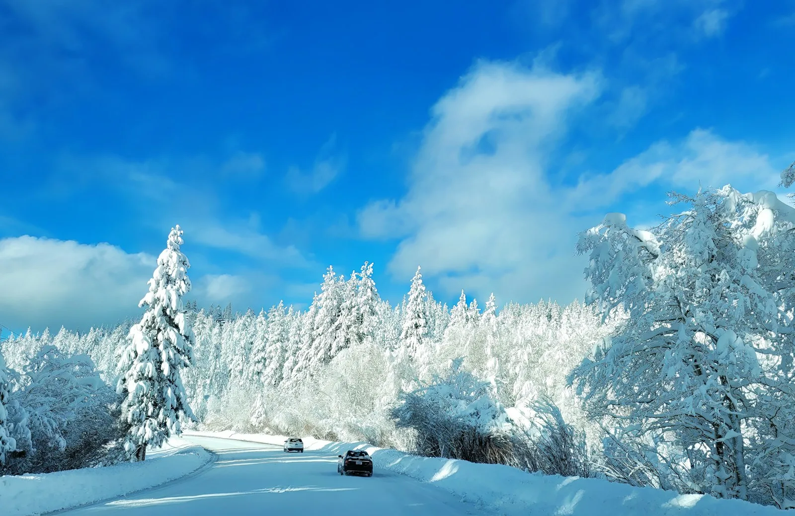 A car driving down a snow covered road