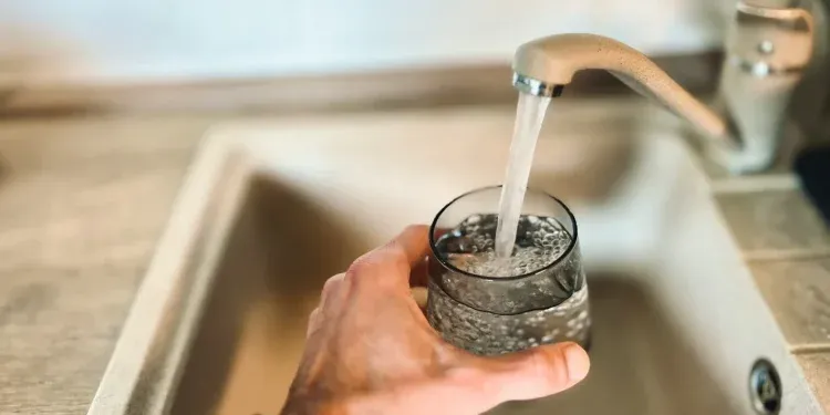 a hand holding a glass of water